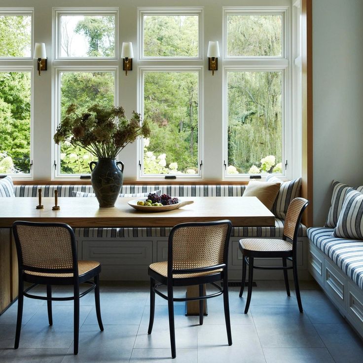 a table with two chairs and a vase on it