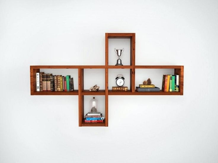 three wooden shelves with books on them and a clock mounted to the wall behind them