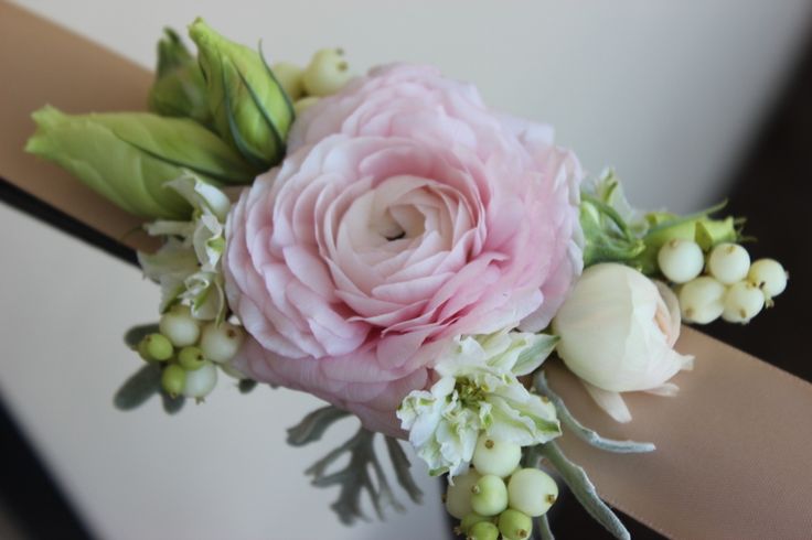 a bouquet of pink flowers and greenery is on the edge of a window sill