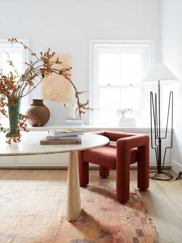 a living room filled with furniture and flowers in vases on top of a table