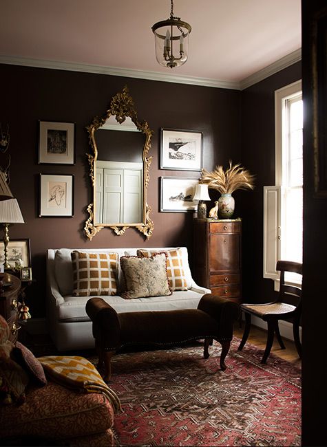 a living room filled with furniture and pictures on the wall