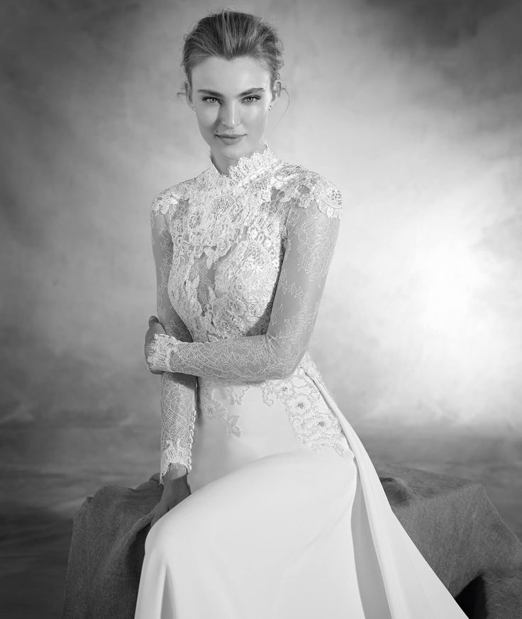 black and white photo of a woman in a wedding dress with her arms folded out