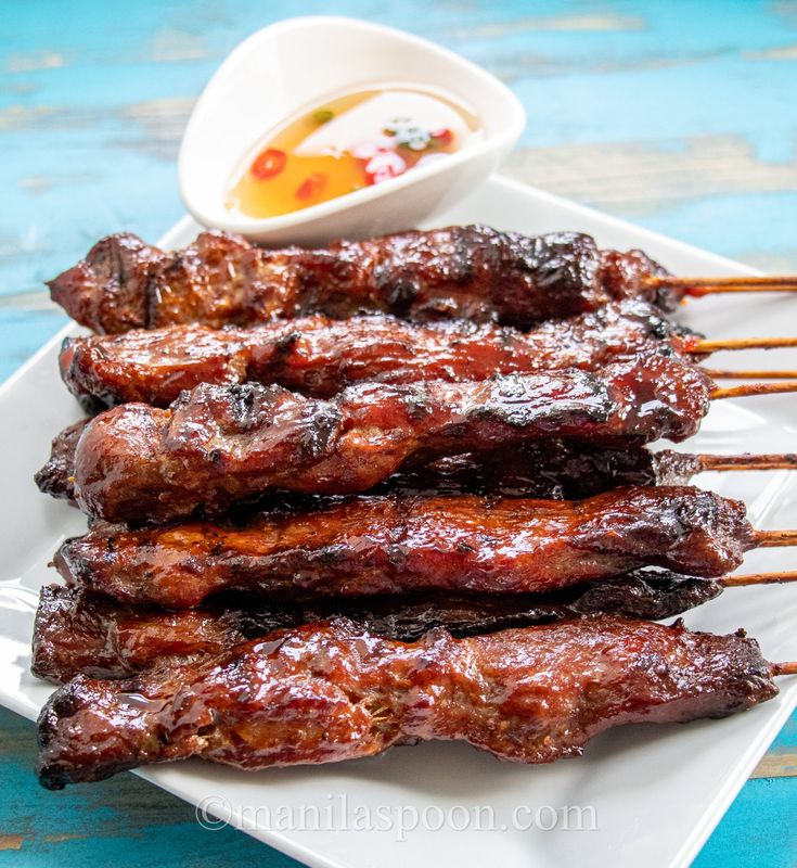 grilled meat on skewers with dipping sauce