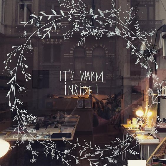 a store window with the words it's warm inside