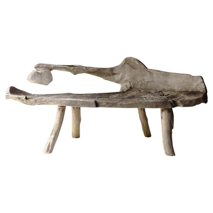 a wooden bench made out of driftwood with one foot on the end and two legs down