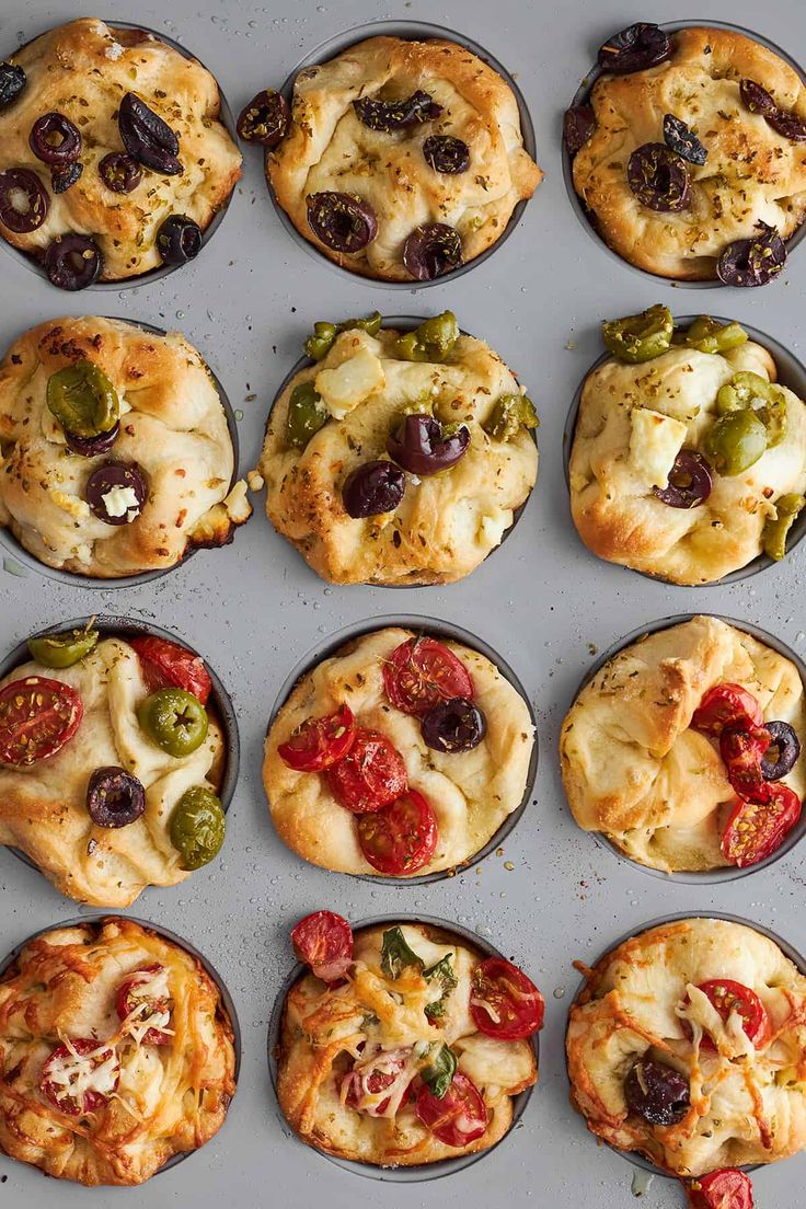 twelve different types of pizzas in muffin tins with toppings on them