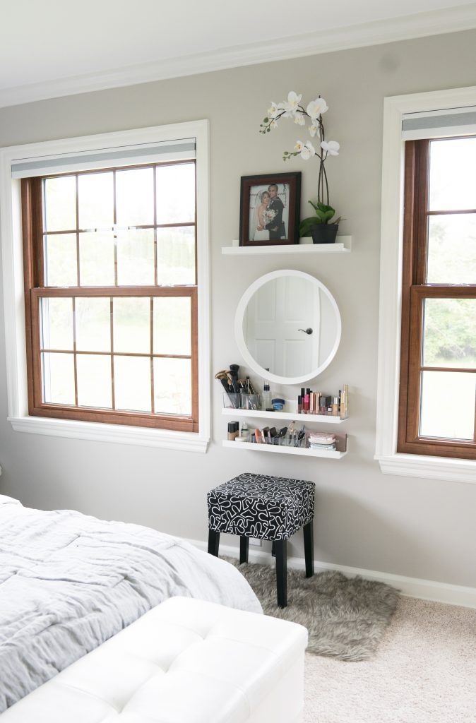 a bedroom with two windows and a white bed