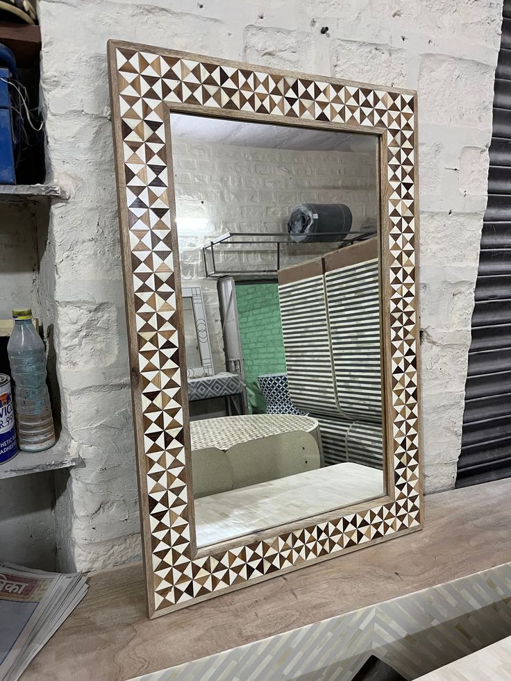 a mirror sitting on top of a wooden table