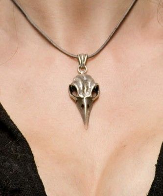 a woman wearing a necklace with a bird's head on it