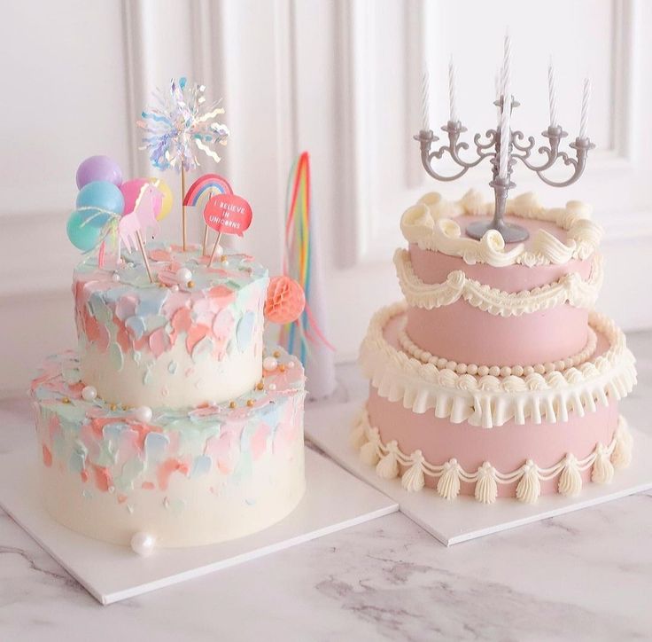 two colorful cakes sitting on top of each other