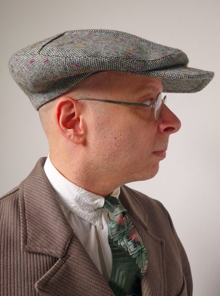 "The EASTMAN - 1910s Pattern Pleated Flat Cap in Vintage Onkaparinga Wool Tweed Incredibly, the 64th design in the Well Dressed Head collection! Based on an original 1910s model, the new Eastman cap is a novelty design from the heyday of Norfolk-pleated suits and jackets. It features double box pleats that swoop back under a horizontal seam to create multiple layers. The wool used here is extremely hard to find vintage stock from the venerable Onkaparinga woolen mills of South Australia. It is a Classic Fitted Visor Hat, Classic Tweed Hat With Short Brim, Classic Tweed Hat With Curved Brim, Classic Brimmed Tweed Hat, Formal Wool Flat Cap, Classic Tweed Brimmed Hat, Classic Tweed Cap, Vintage Wool Baseball Cap, Vintage Tweed Hat With Curved Brim