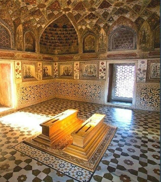 the interior of an ornate building with intricately decorated walls and floor, including a bench