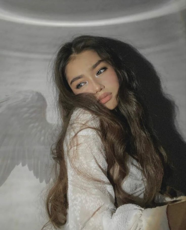 a woman with long hair and an angel wings