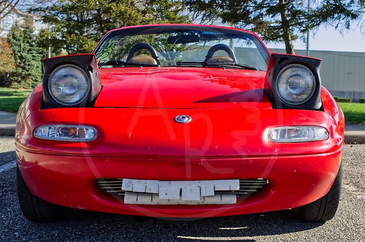 the front end of a red sports car