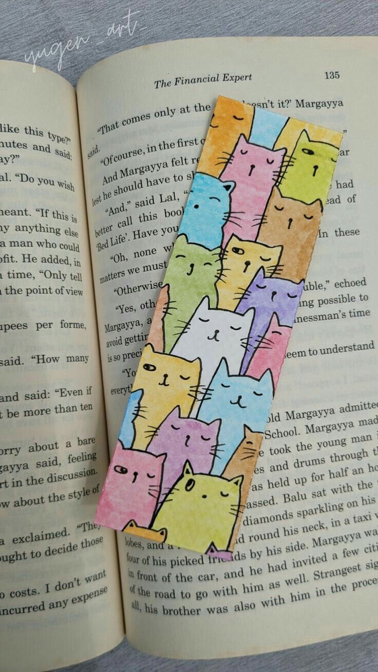 an open book with colorful cats on it's cover and the pages are lined up in rows