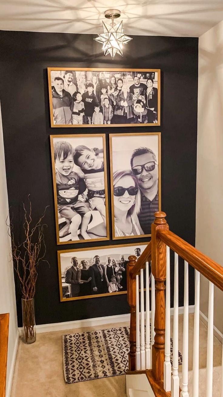 a staircase with pictures hanging on the wall