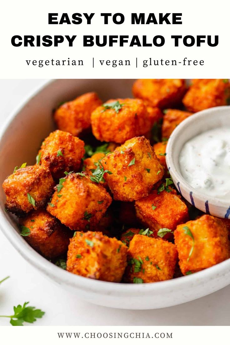 a bowl filled with tater tots and ranch dressing