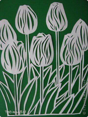 some white flowers on a green background with the words tulips written below them