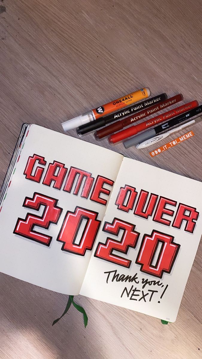 a book with some writing on it next to markers and pencils that say game over