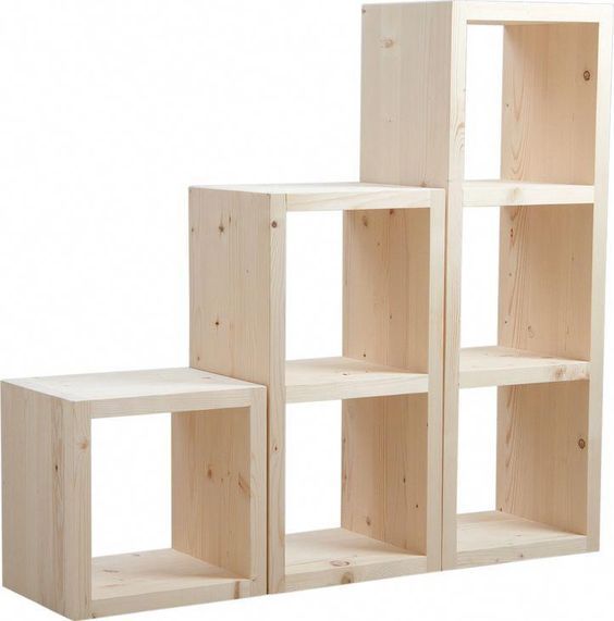 three wooden shelving units sitting side by side