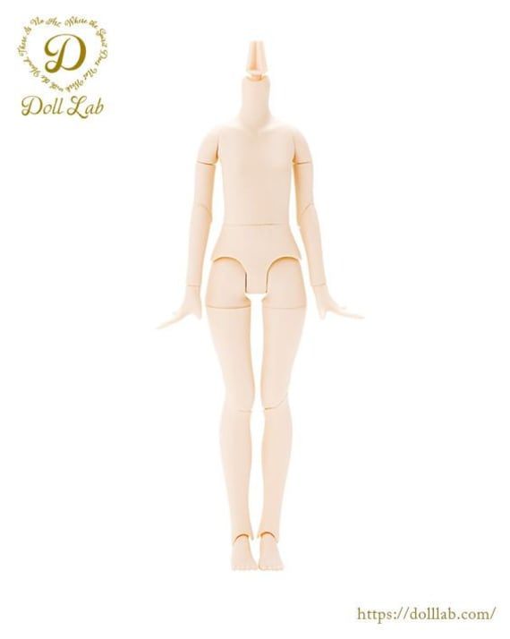 the doll is wearing a white bodysuit and has her hands on her hips as she stands