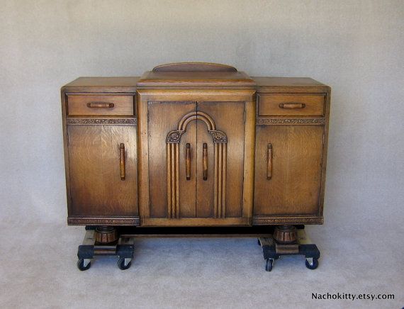 an old fashioned wooden cabinet with wheels