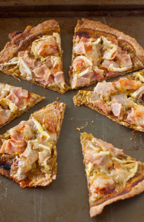 a pizza with slices missing from it sitting on a table