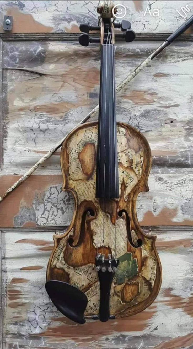 an old violin is hanging on the wall