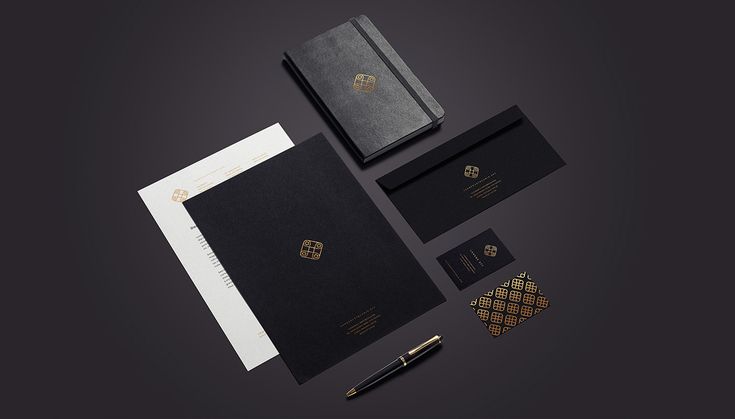 an assortment of stationery items including notebooks, pens and paper on a dark background