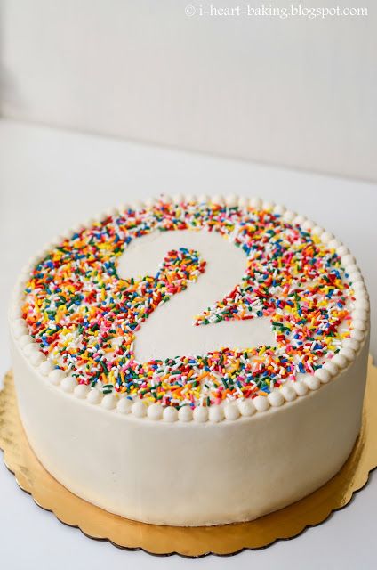 a white cake with sprinkles and a number 2 on it