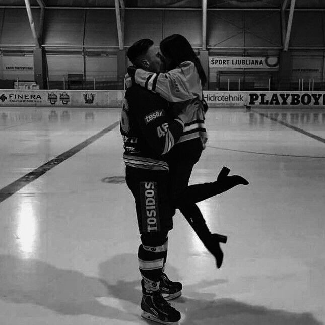 two people are hugging on an ice rink