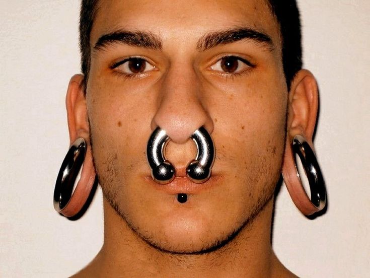 a man with fake piercings on his nose and nose ring in front of him