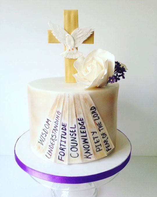 a cake with a cross and flowers on top