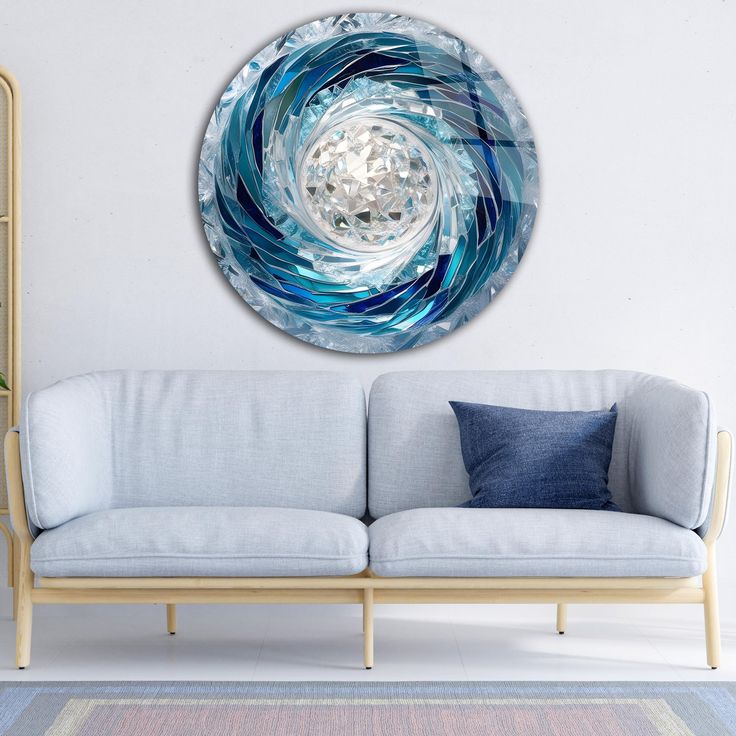 a living room with a white couch and blue wall art on the wall above it