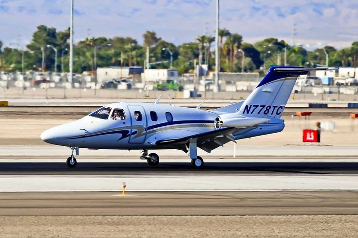 a small blue and white plane is on the runway