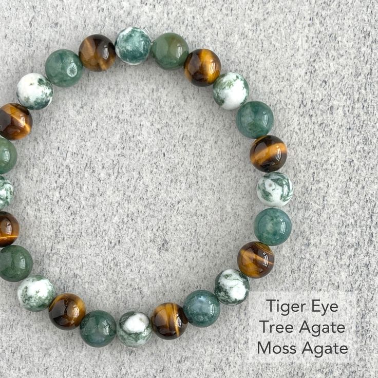 Men's beaded bracelet features: ~ 8mm tree agate beads ~ 8mm moss agate beads ~ 8mm wood jasper beads ~ Stretchy cord; simply slide bracelet on and off wrist ~ Comes packaged in a re-usable microfiber pouch To ensure the perfect fit, please use the bracelet sizing instructions found in the photo gallery. Pinterest Wardrobe, Jasper Bead Bracelet, Slide Bracelet, Wood Bead Bracelet, Men's Bracelets, Tree Agate, Bracelet Men, Diffuser Bracelets, Bracelet Ideas