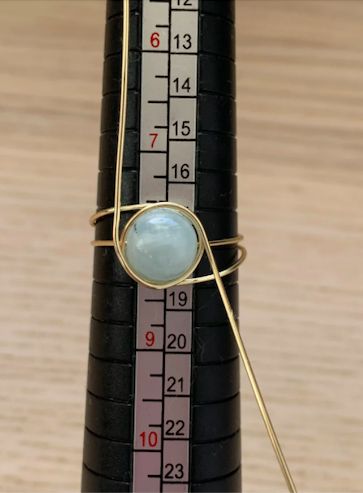 a close up of a bike tire with a measuring tape in the background and a blue stone on it