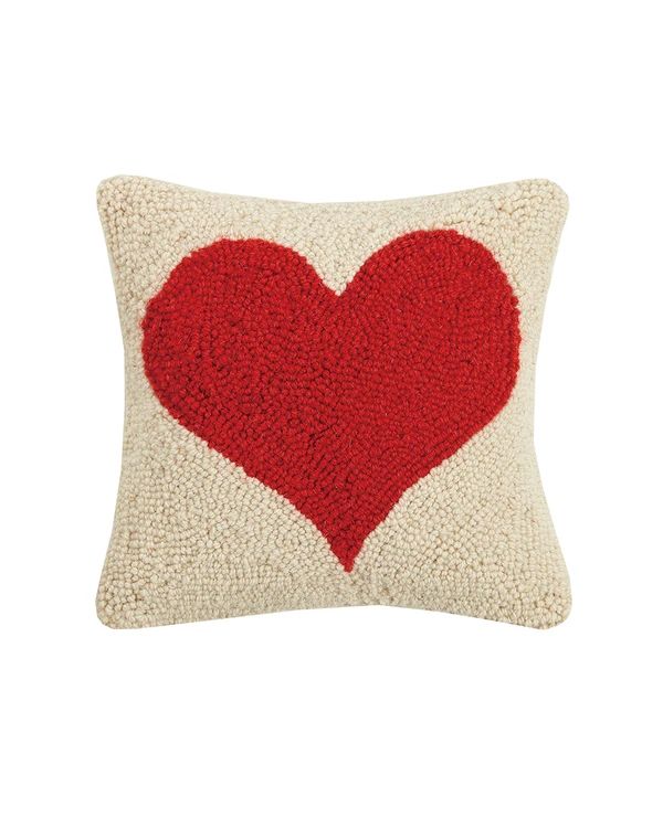 a red heart pillow on a white background