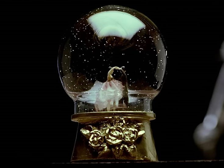 a snow globe sitting on top of a wooden table