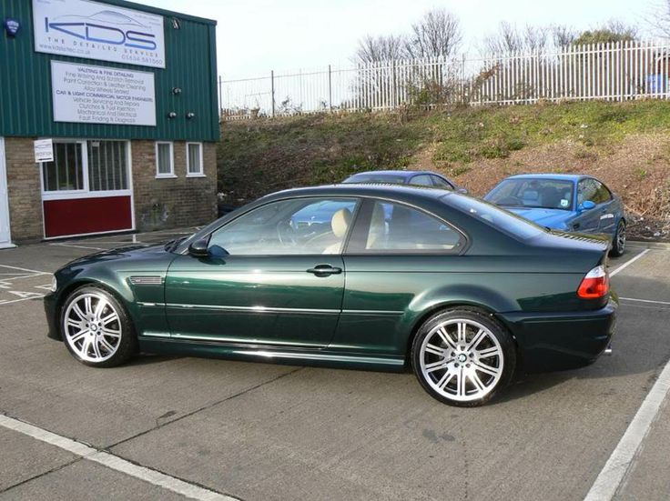 a green car parked in a parking lot