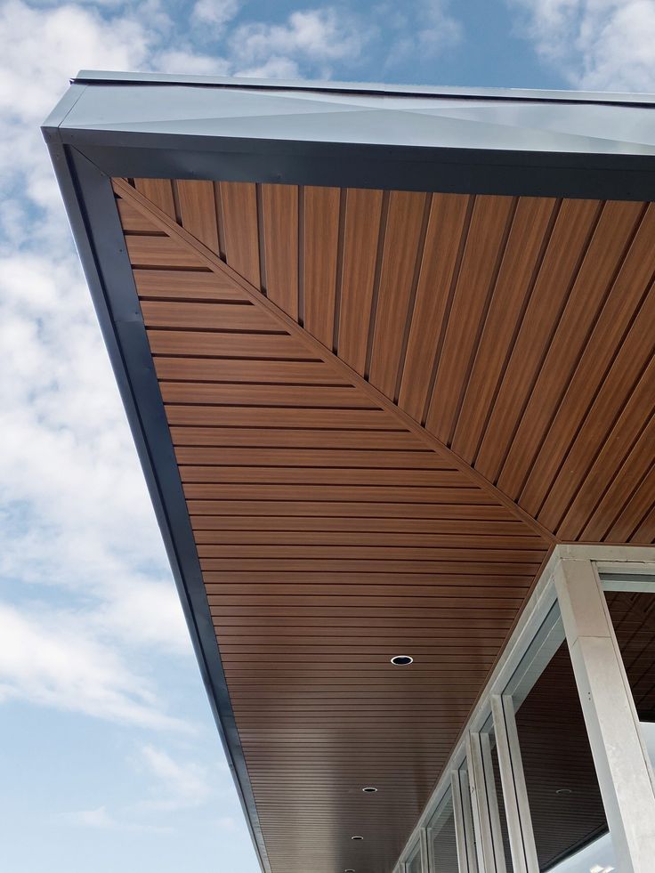 the outside of a building with wooden slats on it