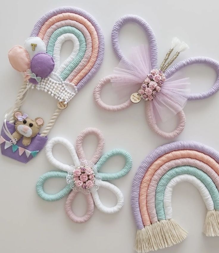 three hair clips with pastel colors and bows on them, one has a teddy bear