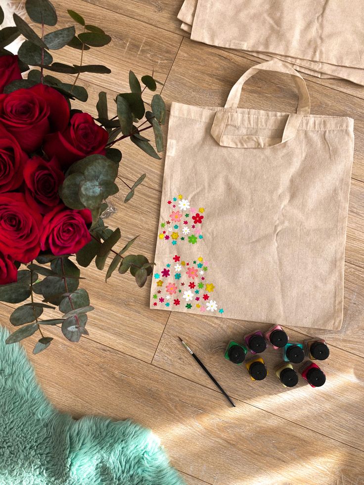 a bag and some flowers on the floor