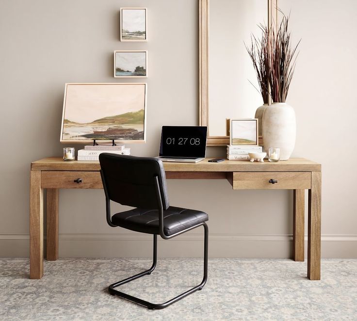 a desk with a chair and mirror in front of it