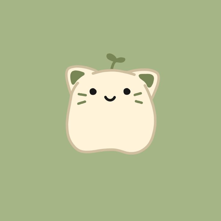 an apple with a cat face on it's side, in the middle of a green background