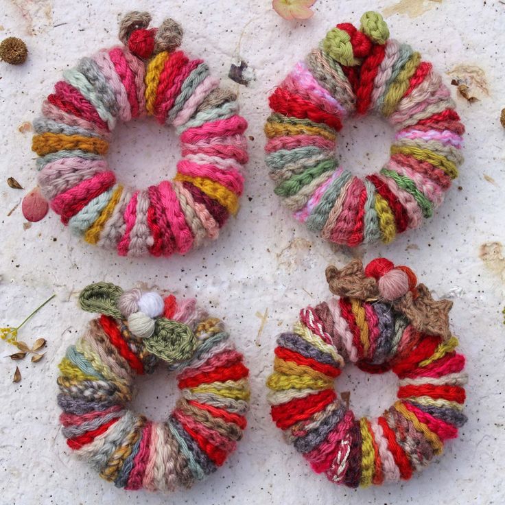 three crocheted hair ties sitting next to each other on a white surface,