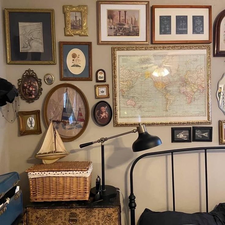 a bed room with a neatly made bed and lots of framed pictures on the wall