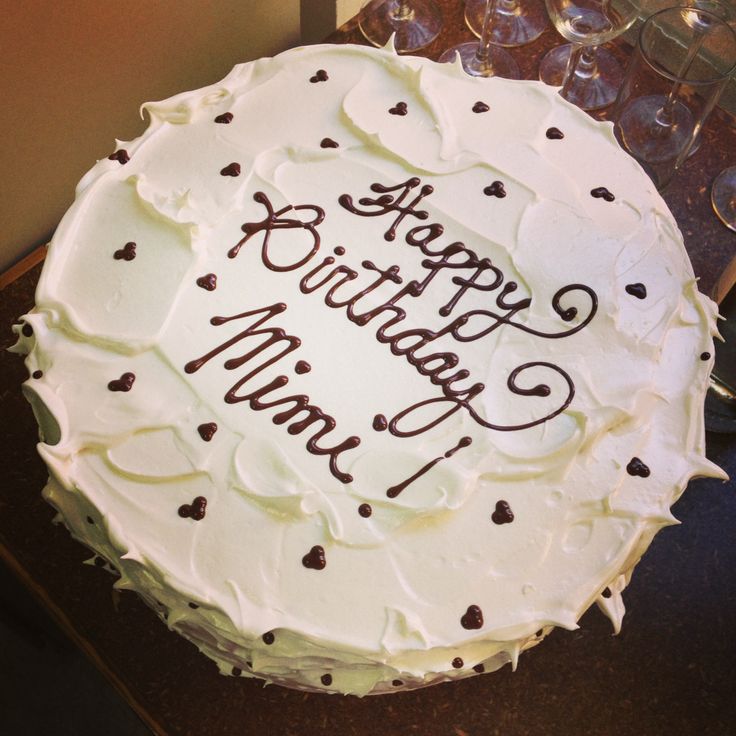 a birthday cake with white frosting and chocolate sprinkles