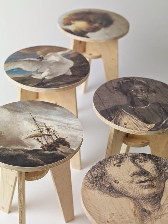 four wooden stools with paintings on them