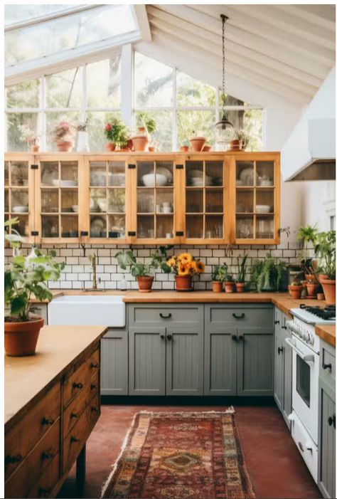 a kitchen filled with lots of green plants and wooden cabinets next to a white stove top oven